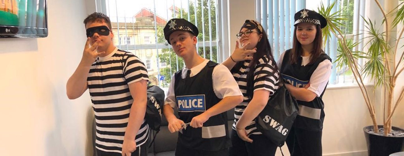 Bury College A-level Drama students dressed as cops and robbers