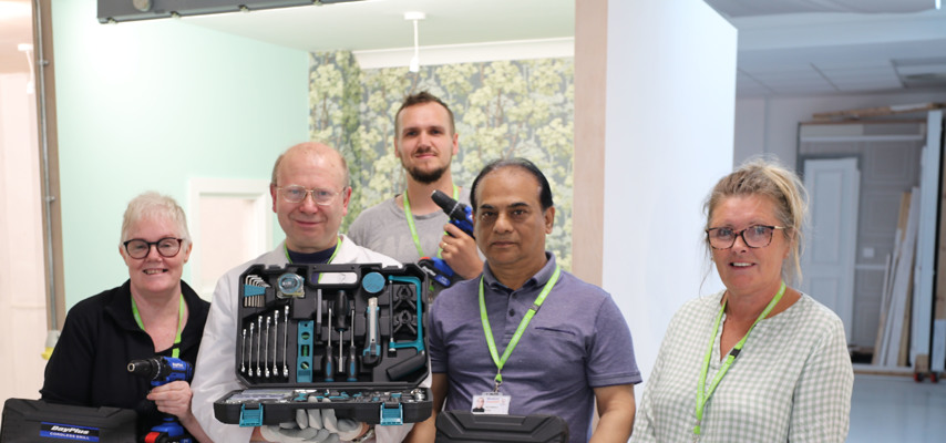 Adult construction students with tools kit
