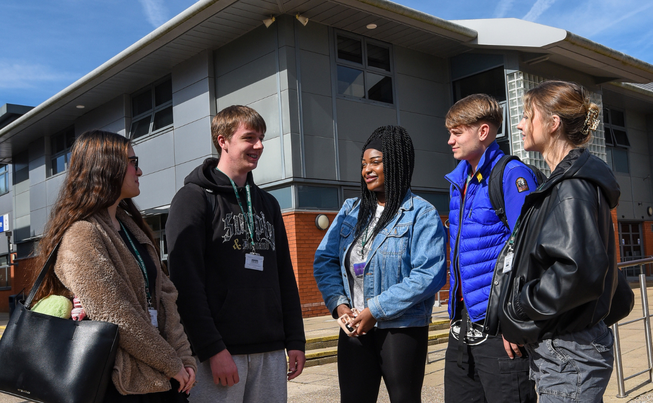 a group of students stood socialising