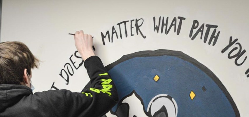 Art student painting a mural
