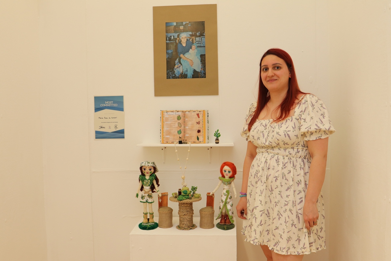 Bury College student stood next to their art work