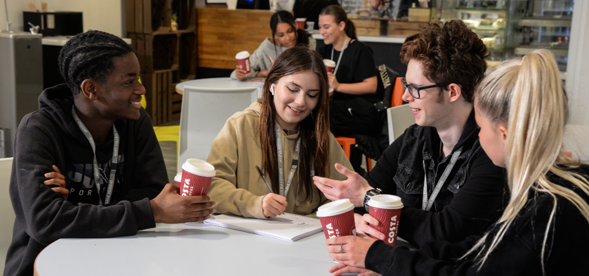 students sat in a canteen space socialising