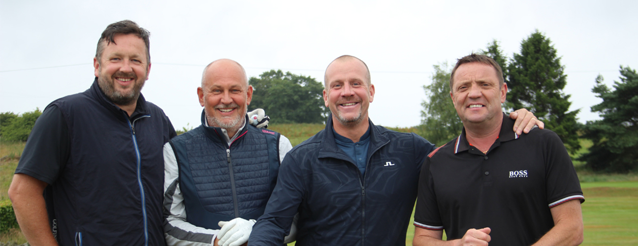 Employers smiling while stood on golf course