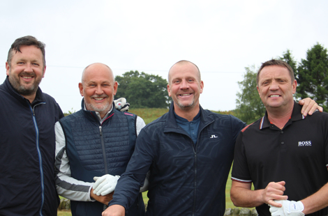 Employers smiling while stood on golf course