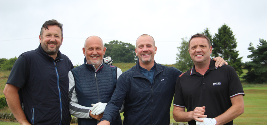 Employers smiling while stood on golf course