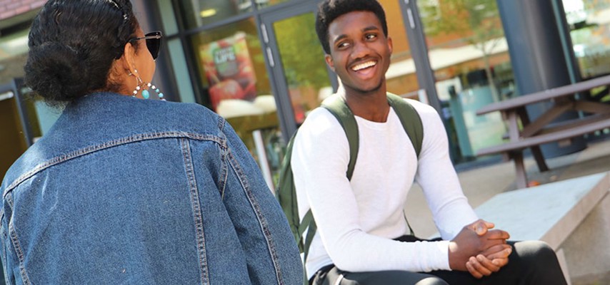 Two students sat outside