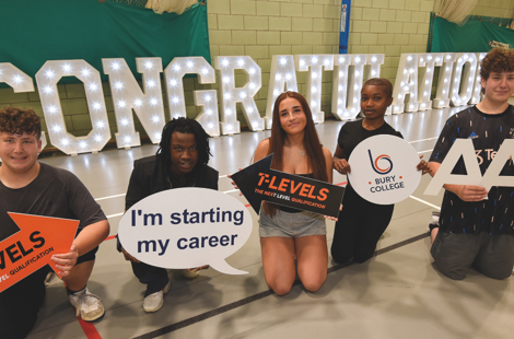 a row of students in front of a congratulations sign