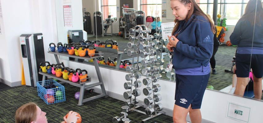 Sport Staff offering advice to a Student training