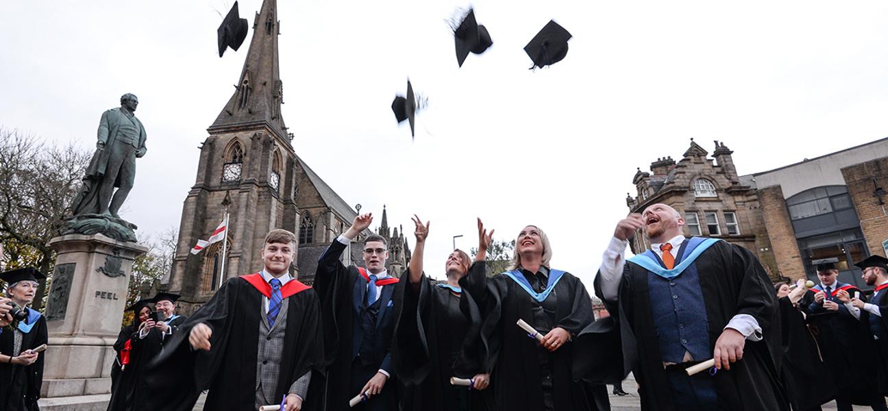 graduates throwing their hats