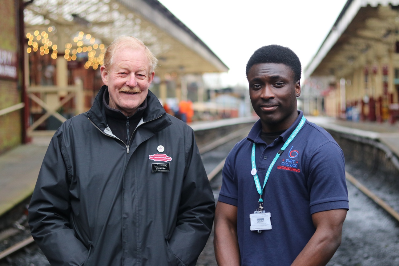 student stood proudly with an employer