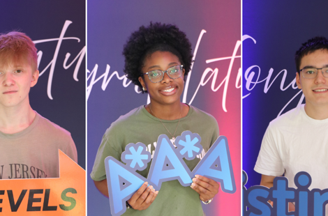 students stood against congratulations signs on results day