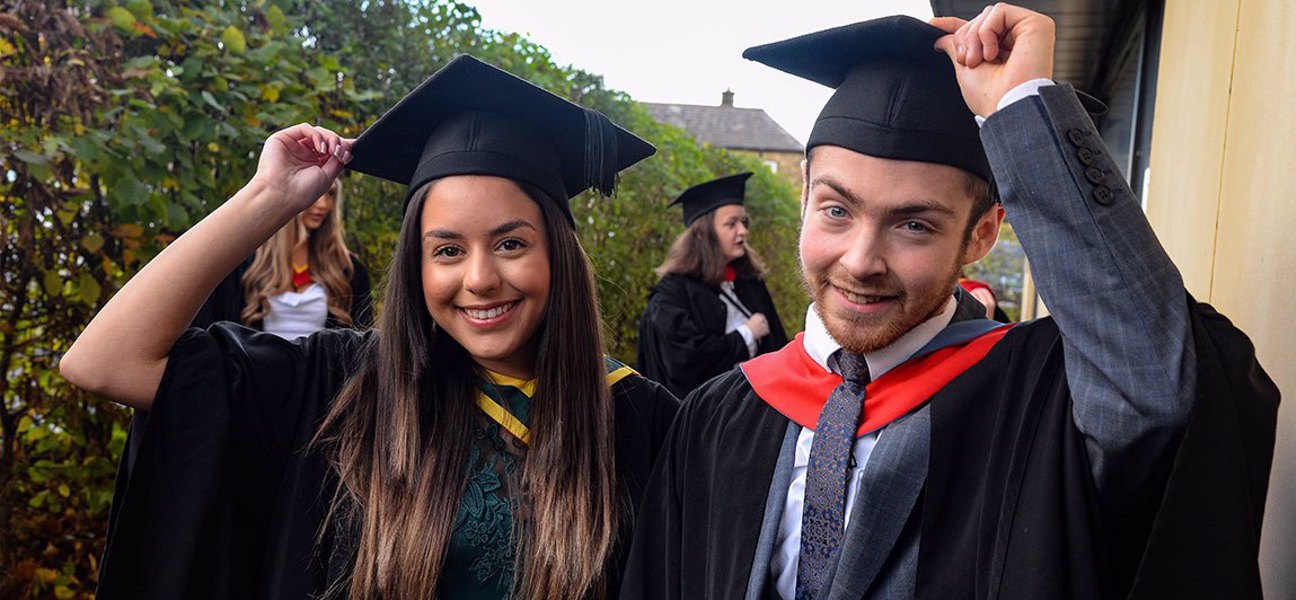 Graduates smiling at the camera