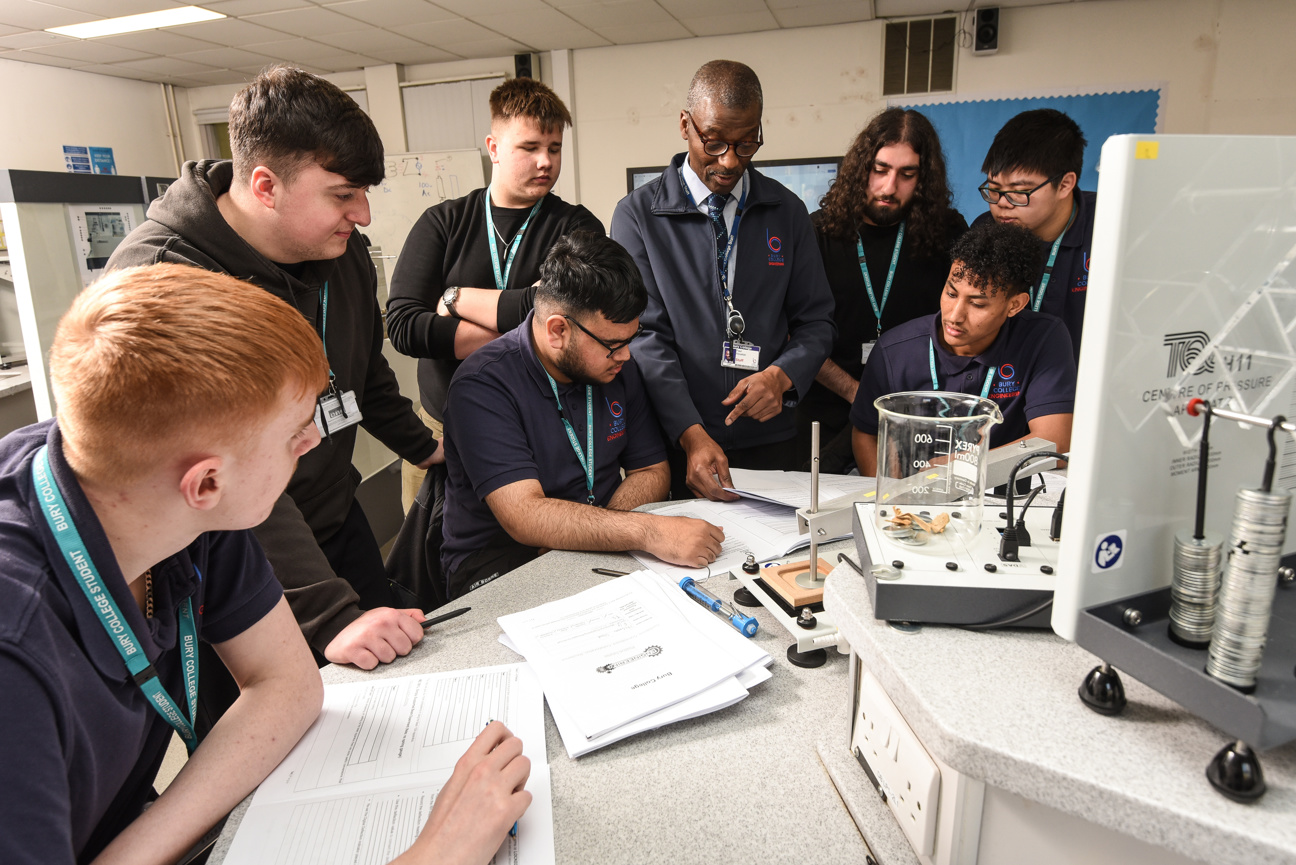 group of engineering students in a class demonstration with teacher