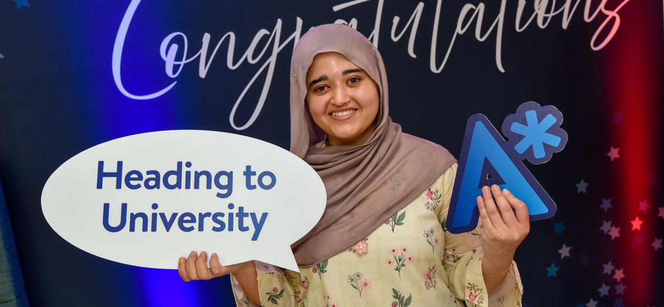 student on results day holding signage