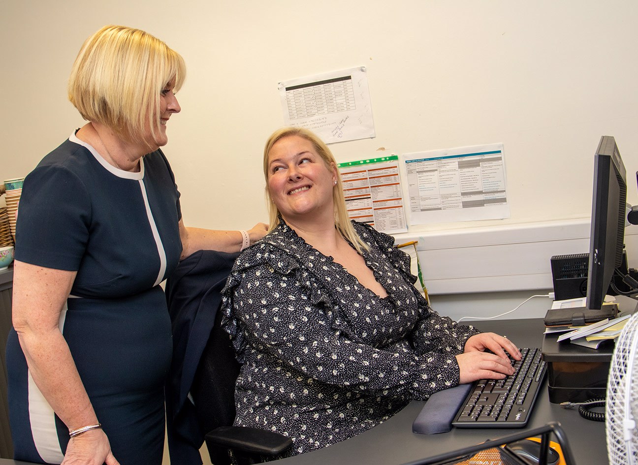 Healthcare apprentice smiling at employer
