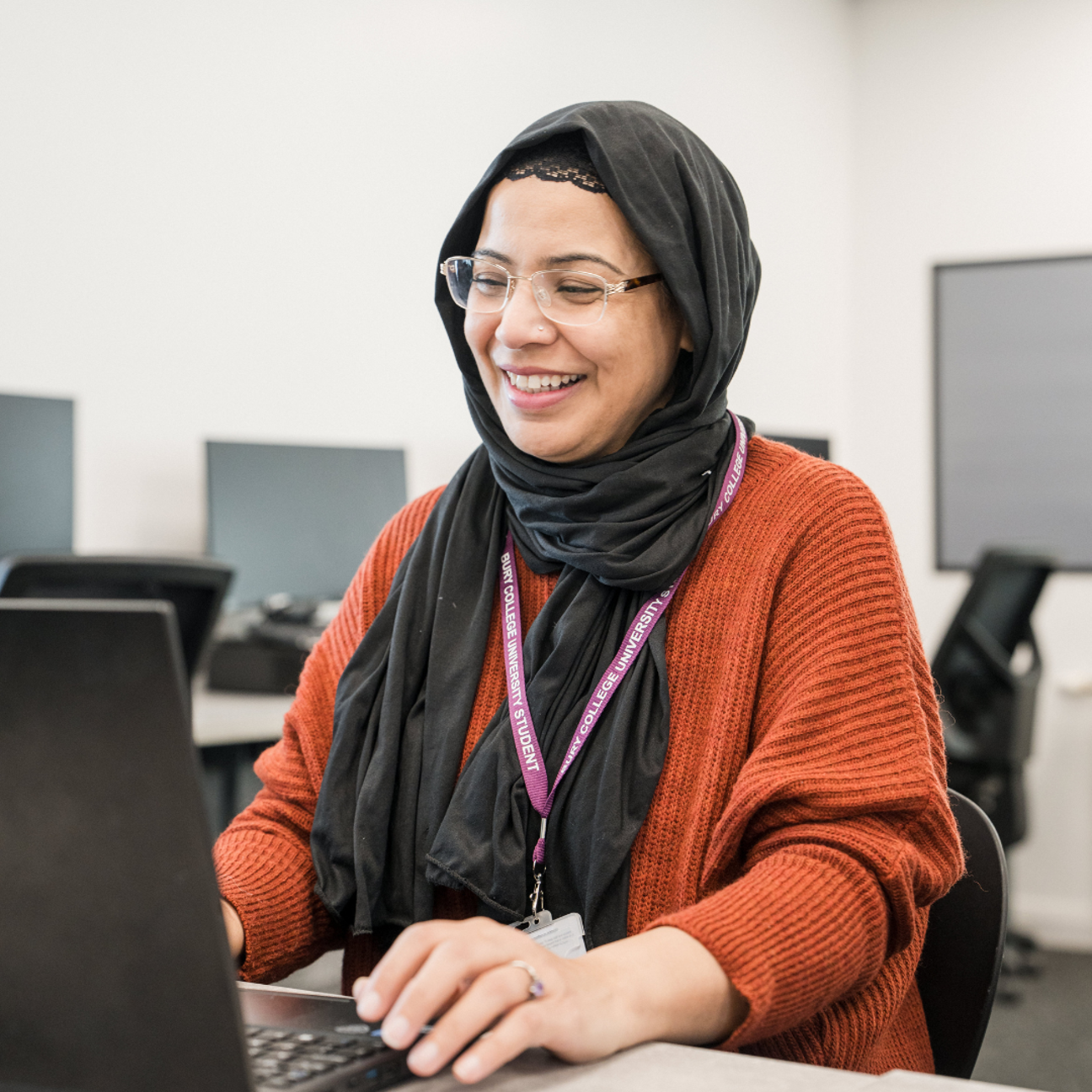 adult learner sat at a computer working