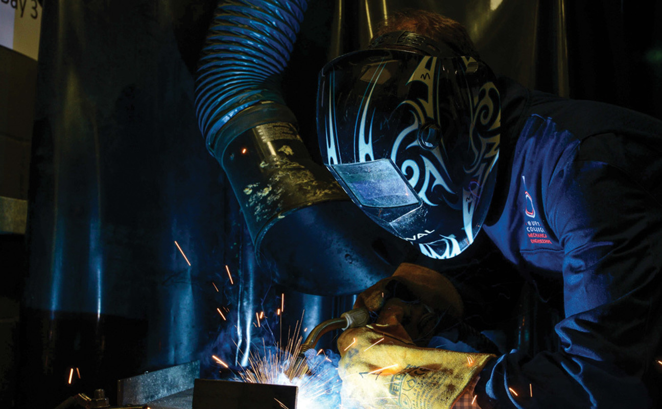 Engineering student using welding equipment