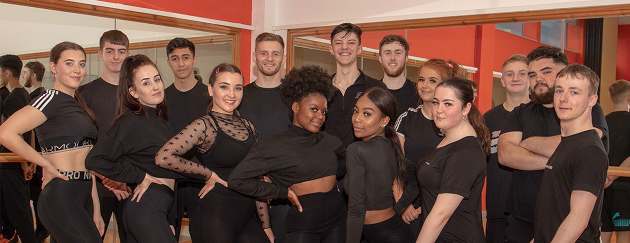 A group of Bury College School of Performance students dressed in black