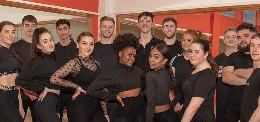 A group of Bury College School of Performance students dressed in black