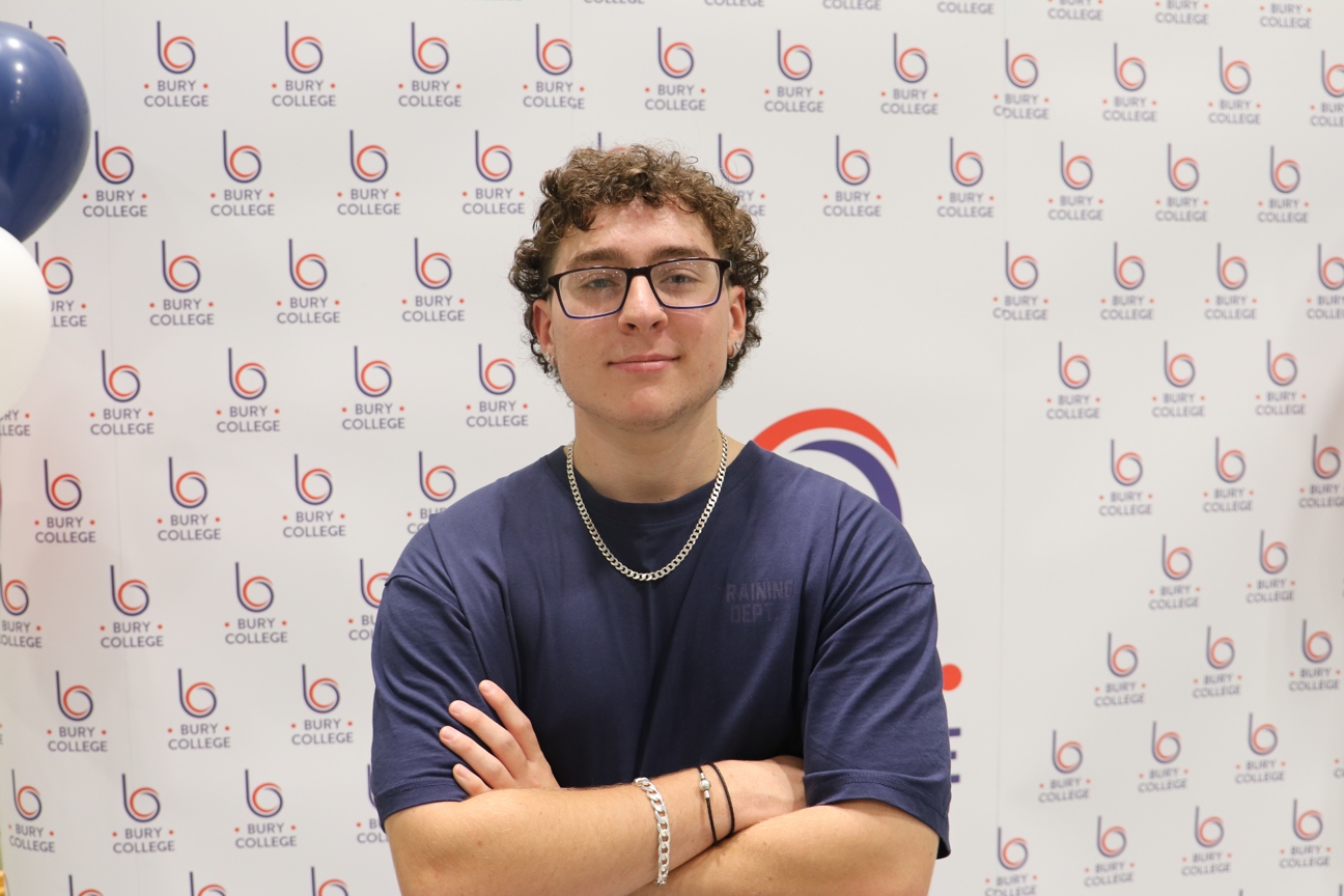 student smiling against Bury College backdrop