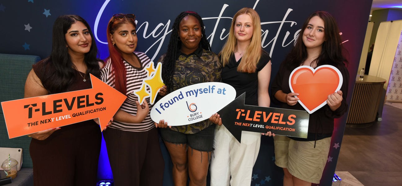 a group of students stood holding up signs