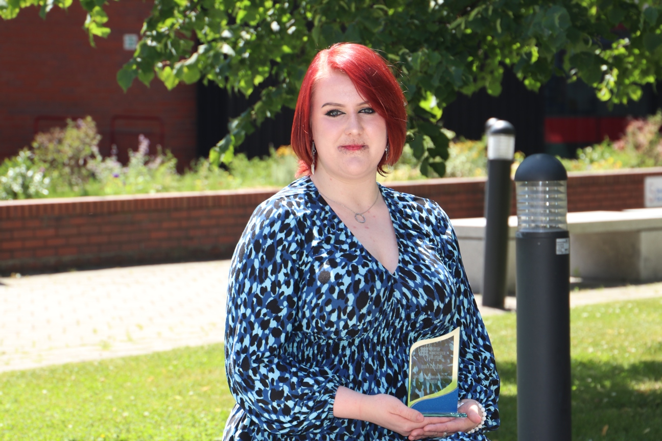 Holly Clarke sat holding GM Colleges Alumni Award