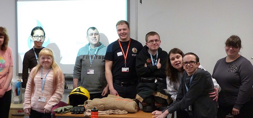 A group photo of Fireman Sam and students
