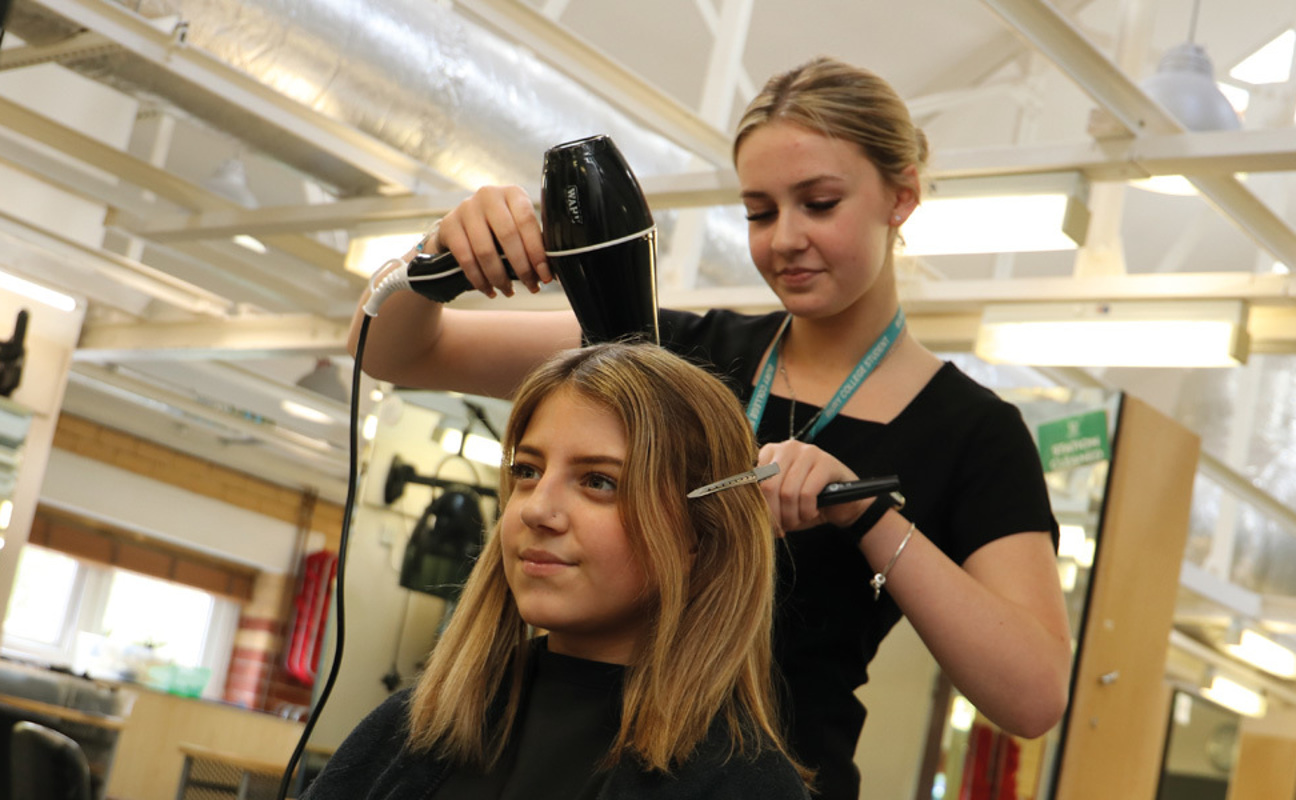 Hairdressing student working on a client