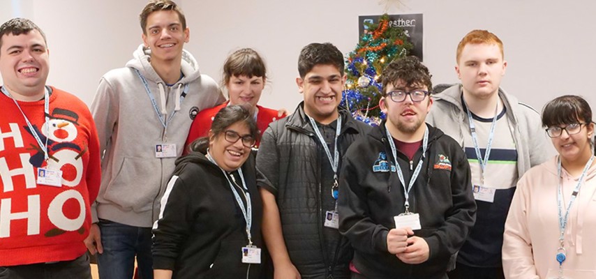 A group of students stood in front of a Christmas tree