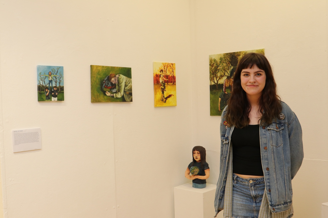 Bury College student stood next to their art work