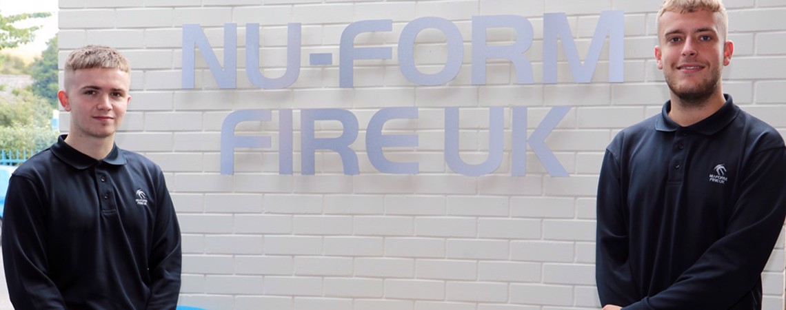Engineering students Max Yates and Tom Frankland stood in front of a Nu-Form Fire UK Sign