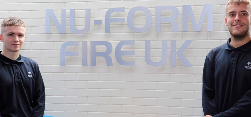 Engineering students Max Yates and Tom Frankland stood in front of a Nu-Form Fire UK Sign