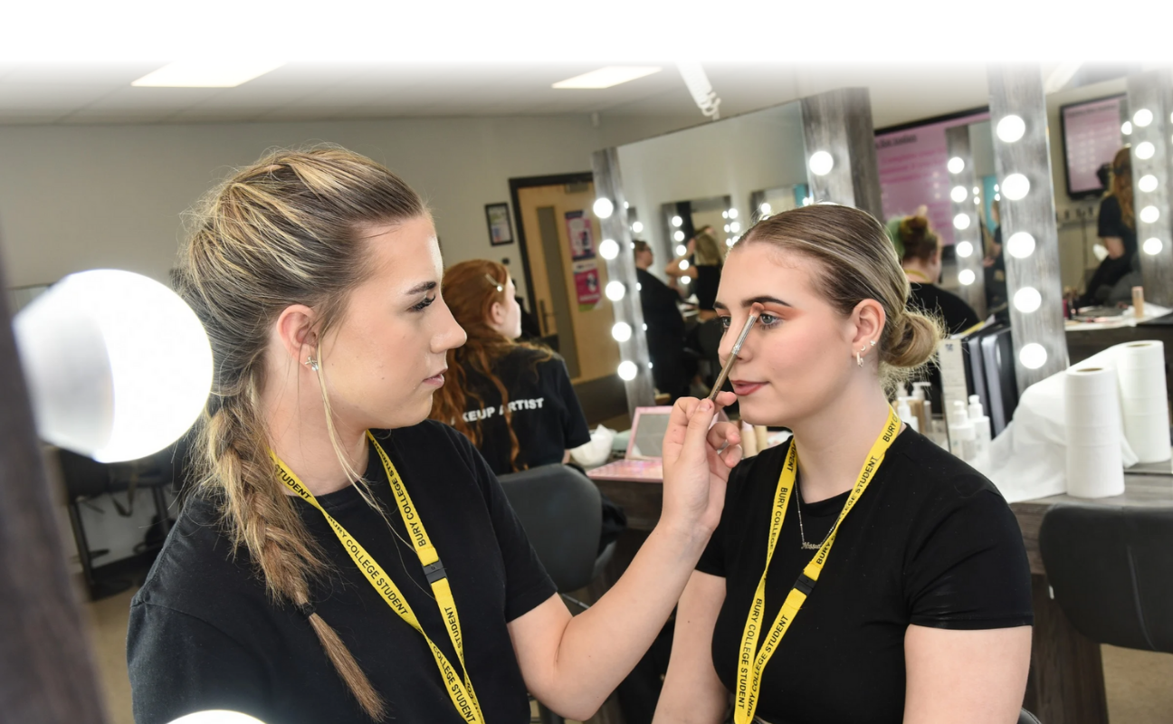 Hair and Media Make Up student doing another students makeup
