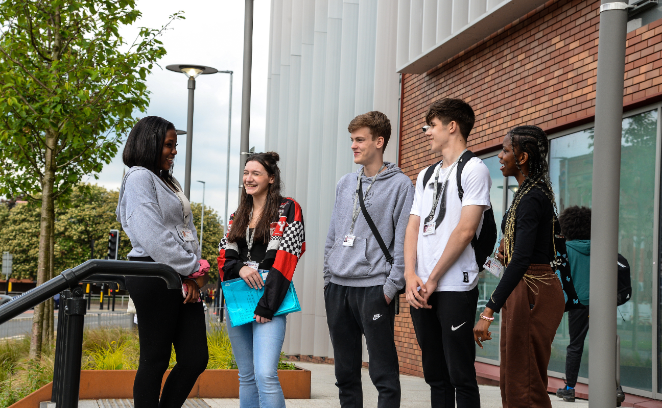 a group of students stood in a group talking