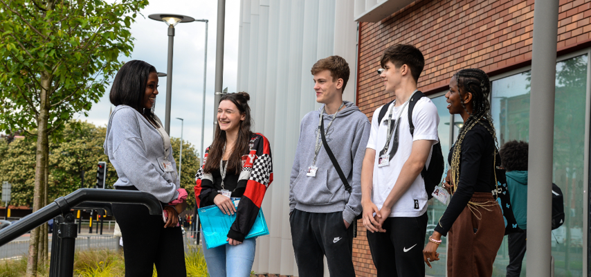 a group of students stood in a group talking