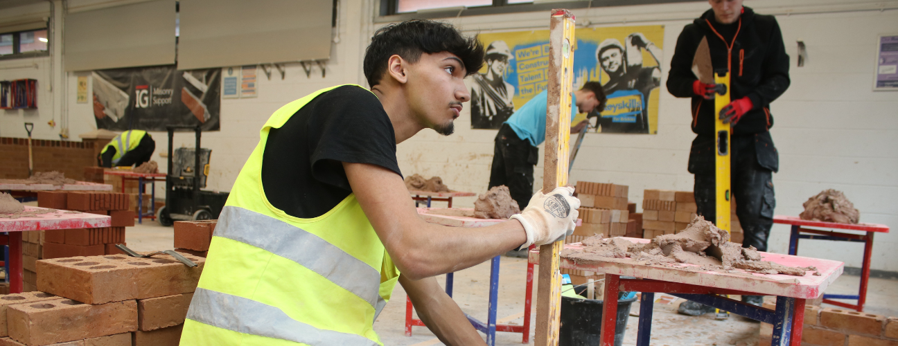 bricklaying student using a spirit level
