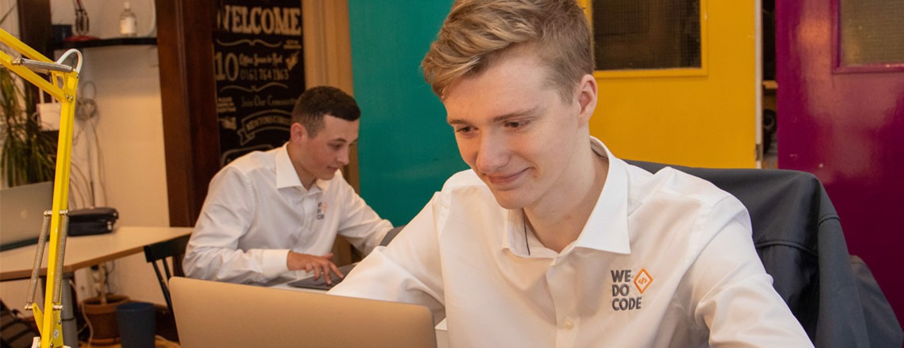 Two students from Bury College working at We Do Code, a software development business based in Bury
