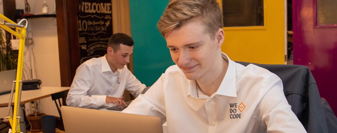 Two students from Bury College working at We Do Code, a software development business based in Bury