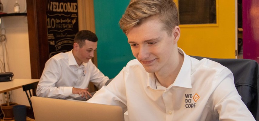 Two students from Bury College working at We Do Code, a software development business based in Bury