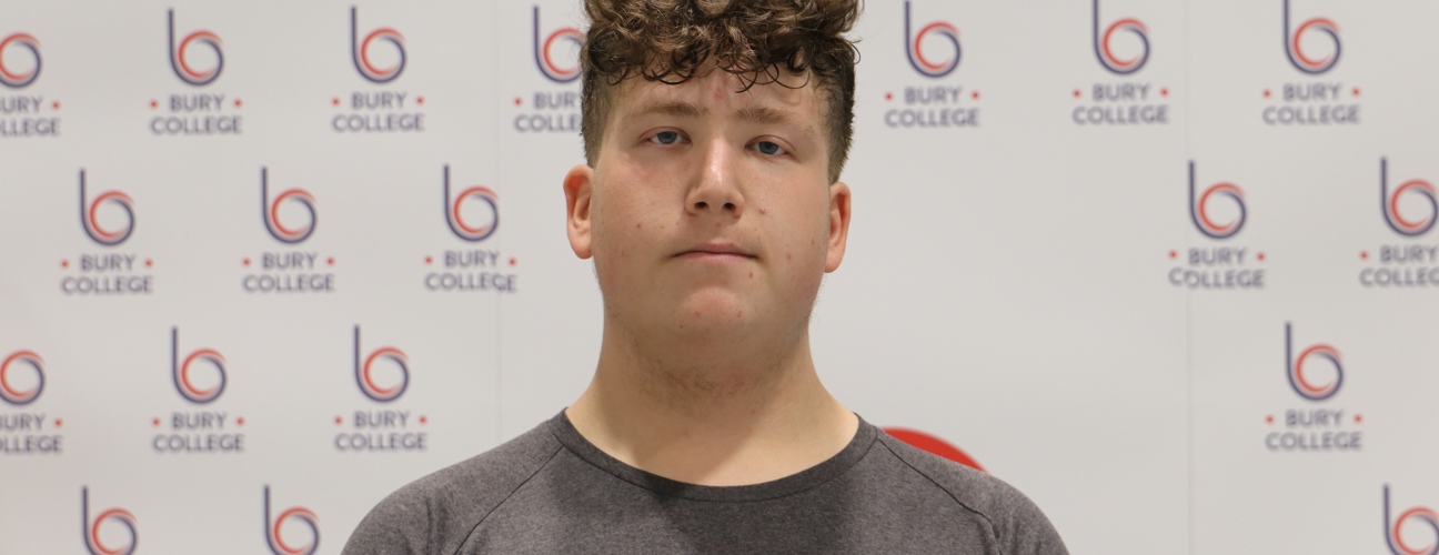 student smiling against Bury College backdrop