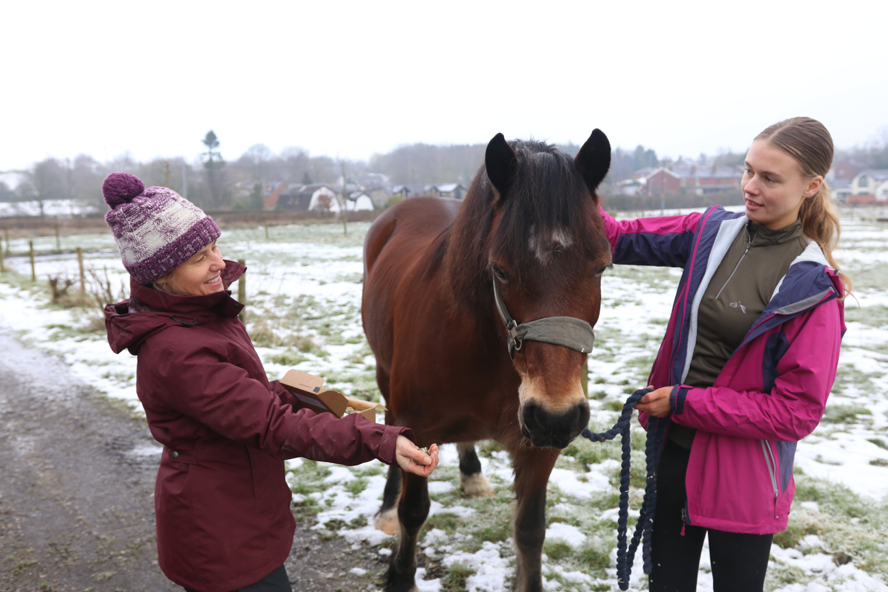 student and employer stood with horse