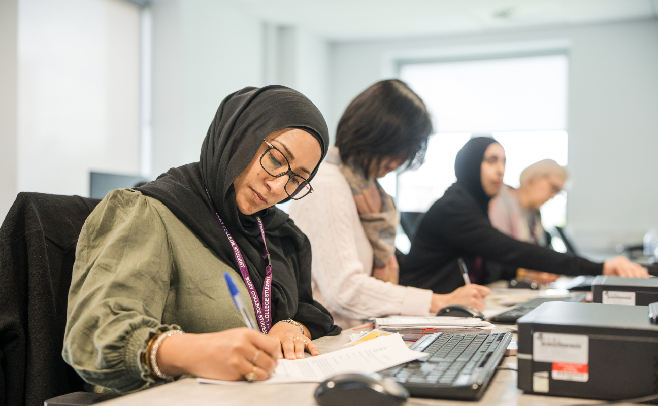 Adult learners writing in class