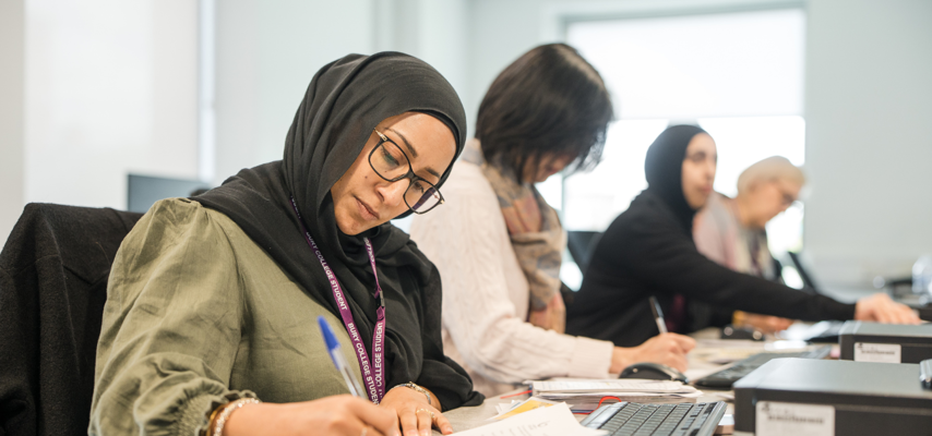 Adult learners writing in class