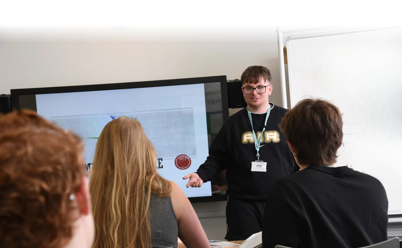 student in a classroom giving a presentation