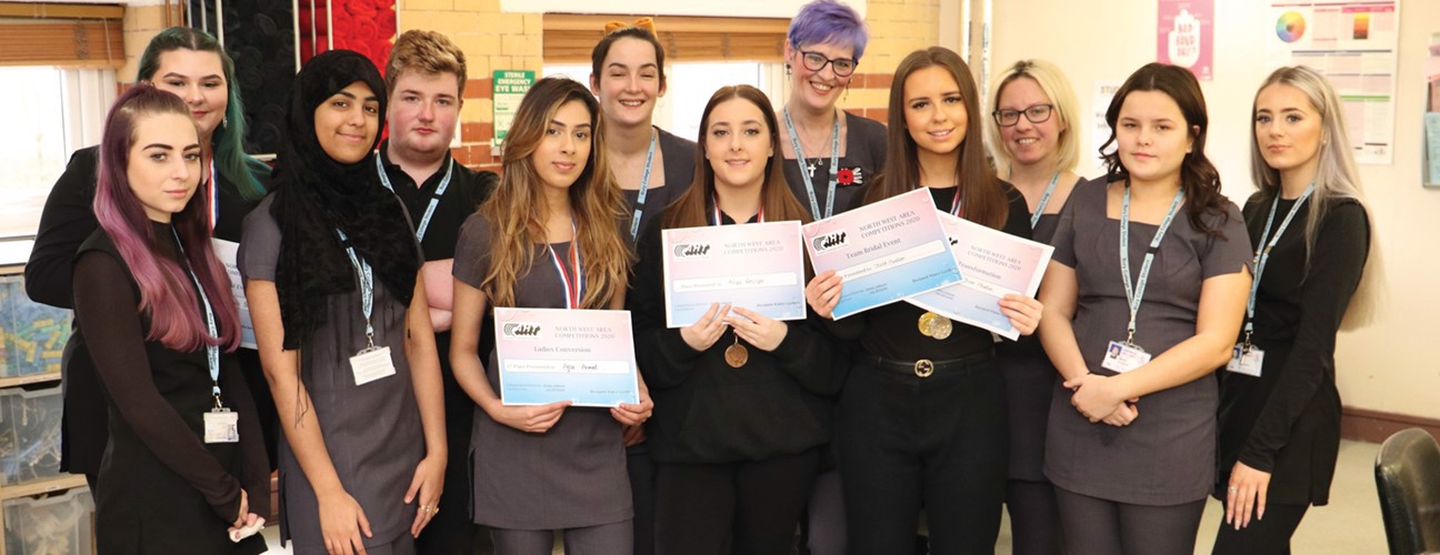 A group of Hairdressing, Barbering and Media Make-up Bury College students holding an award