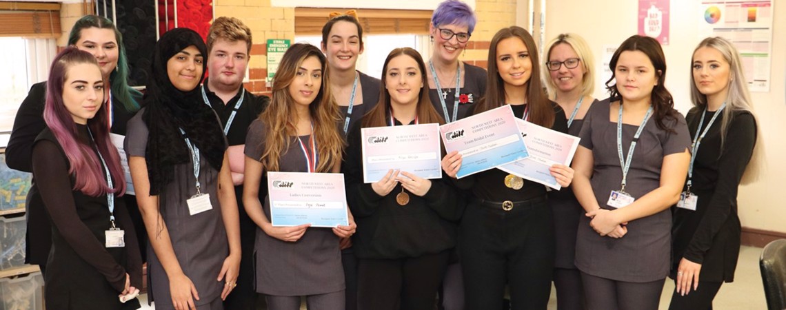 A group of Hairdressing, Barbering and Media Make-up Bury College students holding an award