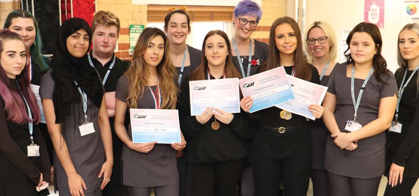 A group of Hairdressing, Barbering and Media Make-up Bury College students holding an award