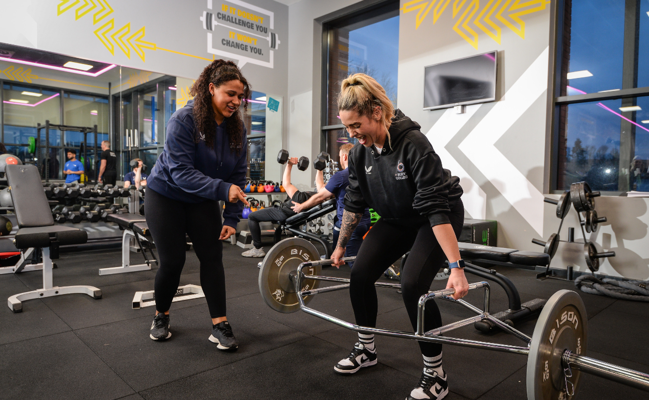 Bury College sport adult learners lifting weights in the gym