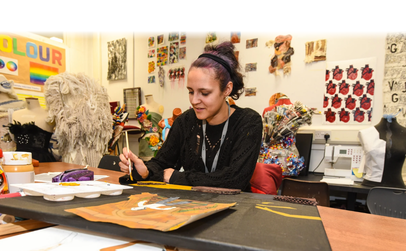 art student in a classroom painting