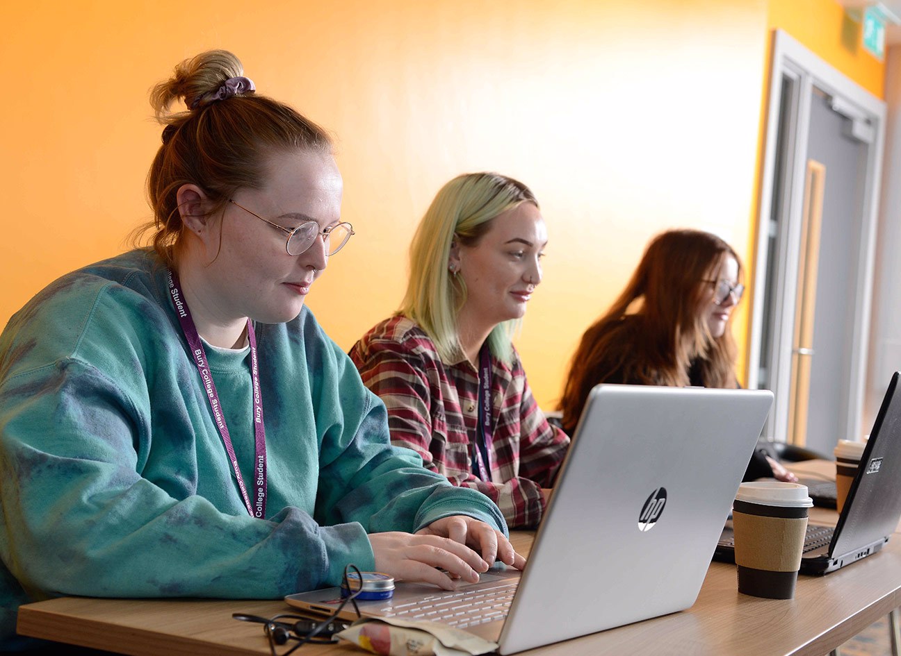 Three students using laptops